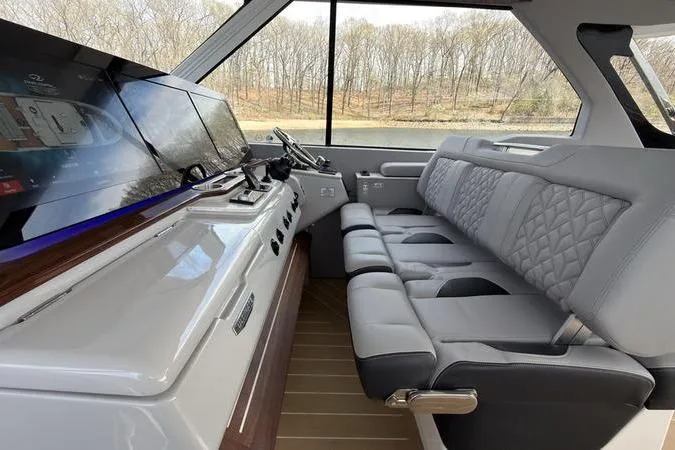Slide: The Image of Luxurious interior of 2025 Regal LX43 boat with plush seating and modern dashboard. - 51