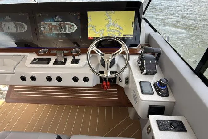 Slide: The Image of Helm of 2025 Regal LX43 boat with advanced navigation displays and controls. - 52