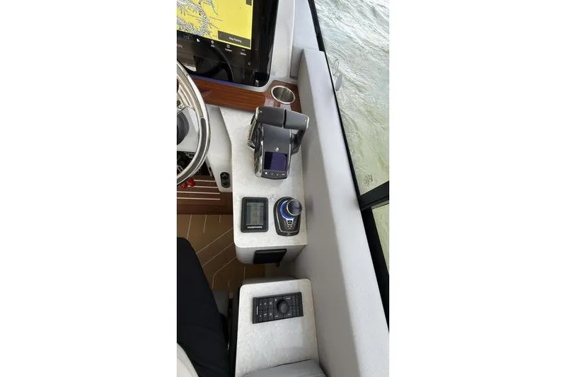 Slide: The Image of Helm of 2025 Regal LX43 boat with navigation controls and display. - 55