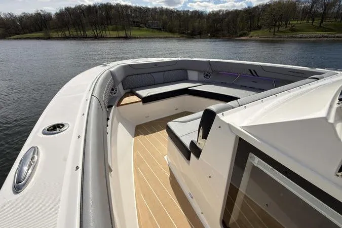Slide: The Image of Luxurious 2025 Regal LX43 boat interior with spacious seating on a serene lake. - 58