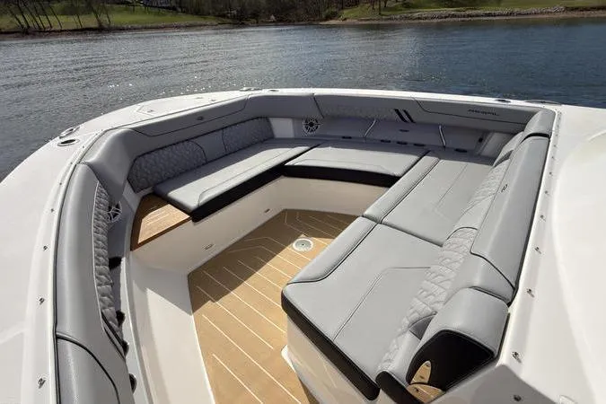Slide: The Image of Luxurious seating area on 2025 Regal LX43 boat, featuring elegant gray upholstery and scenic water backdrop. - 59
