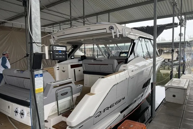 Slide: The Image of 2025 Regal LX43 luxury boat docked in a covered marina. - 6