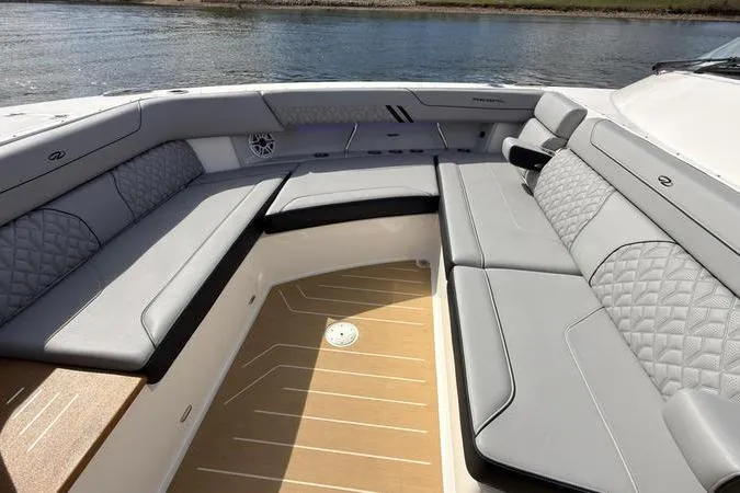 Slide: The Image of Luxurious seating area on 2025 Regal LX43 boat with elegant design and waterfront view. - 60