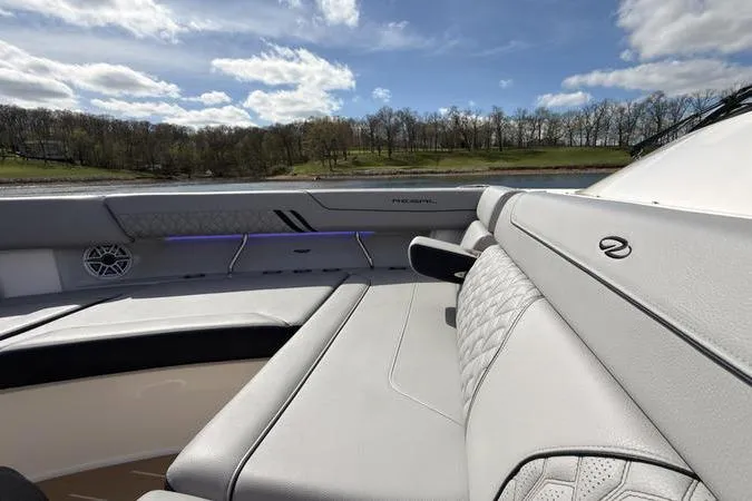 Slide: The Image of Luxurious 2025 Regal LX43 boat interior with plush seating and scenic lake view. - 63