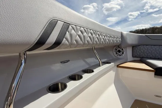 Slide: The Image of Luxurious interior of 2025 Regal LX43 boat with quilted upholstery and cup holders. - 68