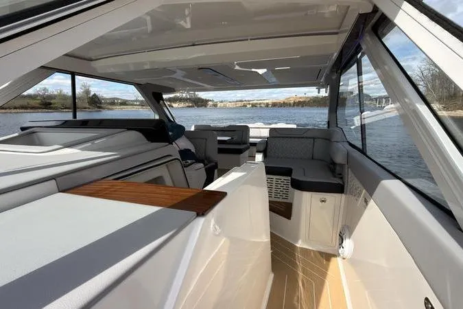 Slide: The Image of Luxurious interior of 2025 Regal LX43 yacht with modern seating and panoramic windows. - 69