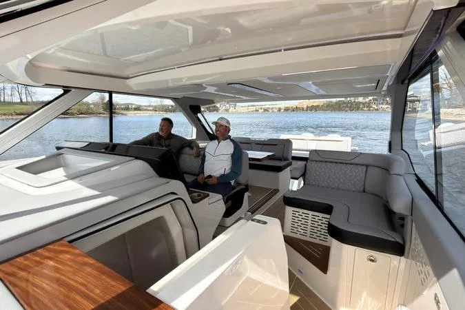 Slide: The Image of Luxurious interior of 2025 Regal LX43 yacht with two people enjoying the view. - 70
