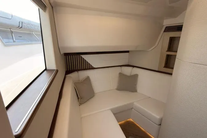 Slide: The Image of Luxurious interior of 2025 Regal LX43 yacht with elegant white seating and cushions. - 71