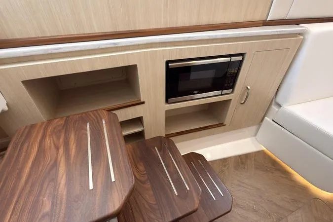 Slide: The Image of Interior of 2025 Regal LX43 yacht with wooden steps and built-in microwave. - 74