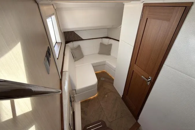 Slide: The Image of Luxurious interior of 2025 Regal LX43 yacht with cozy seating and elegant wood finishes. - 76