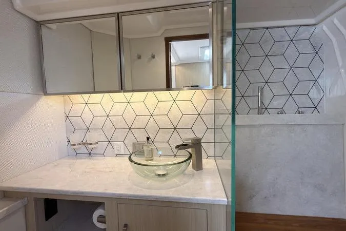 Slide: The Image of Luxurious bathroom in 2025 Regal LX43 yacht with modern glass sink and geometric tiles. - 77