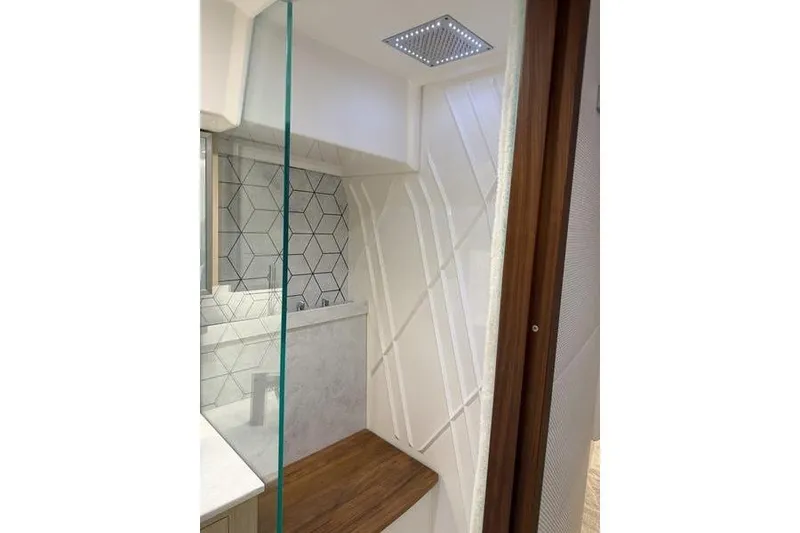 Slide: The Image of Luxurious shower interior in 2025 Regal LX43, featuring modern geometric tiles and wooden accents. - 78