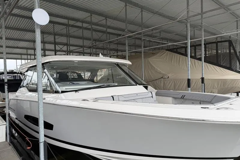 Slide: The Image of 2025 Regal LX43 luxury boat docked in a covered marina. - 8