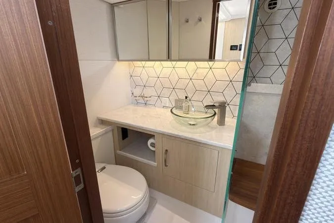 Slide: The Image of Modern bathroom in 2025 Regal LX43 yacht with glass sink and geometric tiles. - 80