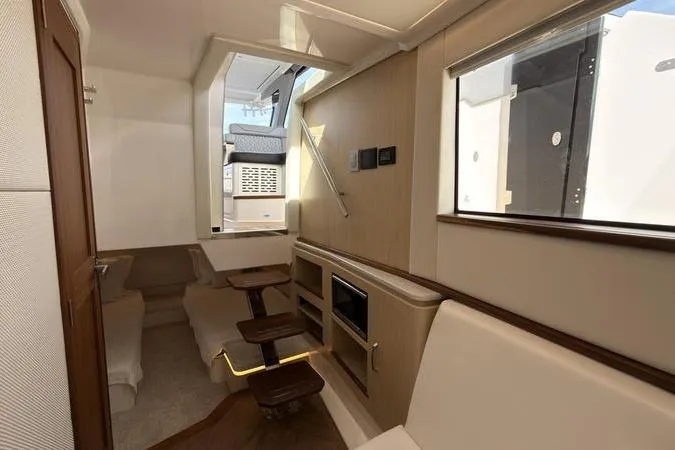 Slide: The Image of Interior of 2025 Regal LX43 yacht, featuring modern seating and wooden accents. - 88