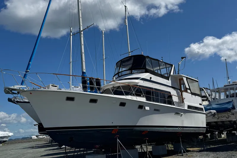 The Image of 1987 Lien Hwa 47 Cockpit Motoryacht on dry dock under a blue sky. - 0