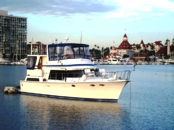 Slide: The Image of 1987 Lien Hwa 47 Cockpit Motoryacht docked with historic backdrop. - 1