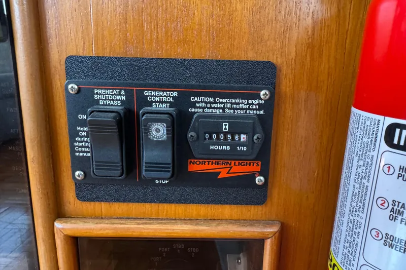 Slide: The Image of Control panel of a 1987 Lien Hwa 47 Cockpit Motoryacht with generator switches. - 12