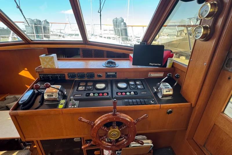 Slide: The Image of 1987 Lien Hwa 47 Cockpit Motoryacht helm with wooden wheel and navigation instruments. - 13