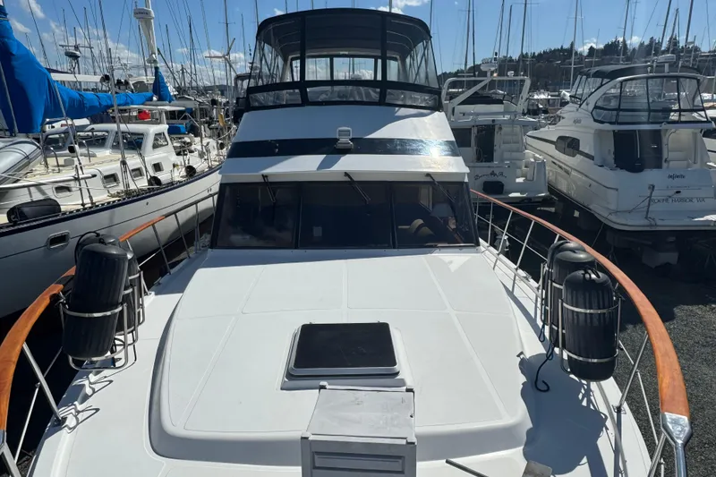 Slide: The Image of 1987 Lien Hwa 47 Cockpit Motoryacht docked among other boats in a marina. - 2