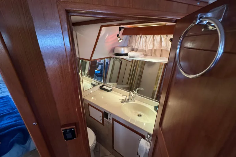 Slide: The Image of Bathroom interior of 1987 Lien Hwa 47 Cockpit Motoryacht with wooden cabinetry and sink. - 21