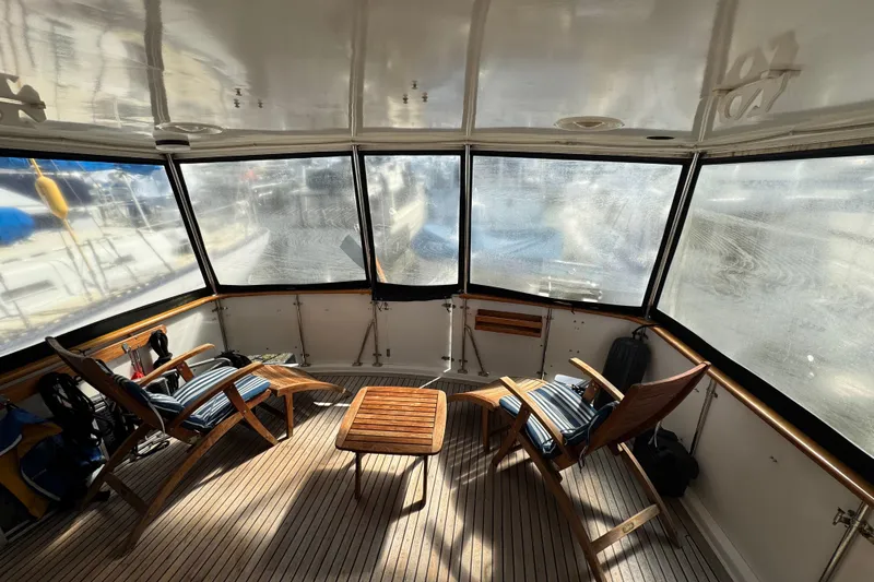 Slide: The Image of 1987 Lien Hwa 47 Cockpit Motoryacht interior with wooden chairs and table. - 22