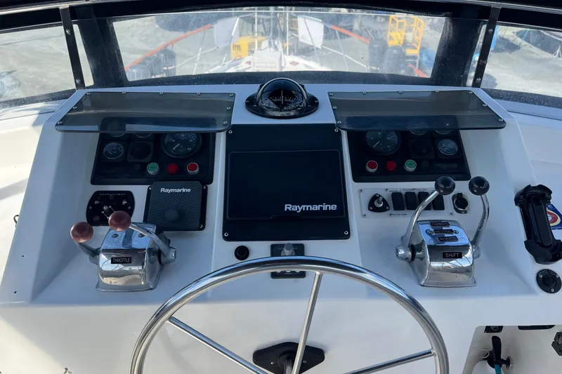 Slide: The Image of Cockpit controls of a 1987 Lien Hwa 47 Cockpit Motoryacht with Raymarine navigation system. - 25