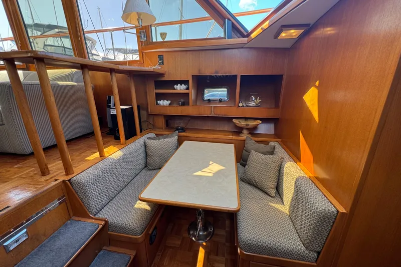 Slide: The Image of Interior of 1987 Lien Hwa 47 Cockpit Motoryacht with cozy seating and wooden decor. - 8