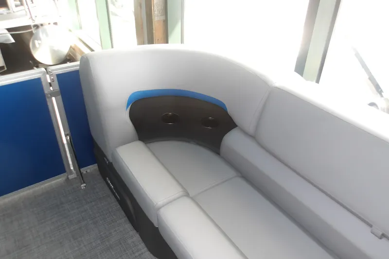 Slide: The Image of 2026 Sun Tracker Party Barge 20 DLX interior seating with cup holders and modern design. - 16