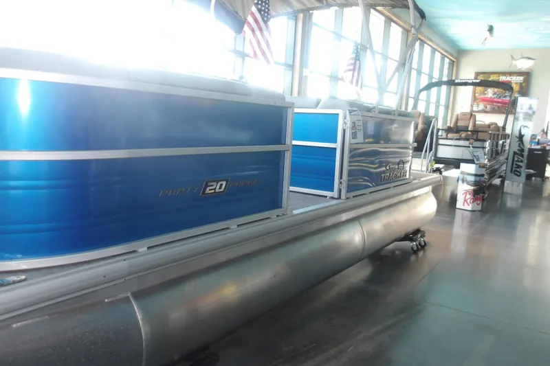 Slide: The Image of 2026 Sun Tracker Party Barge 20 DLX pontoon boat displayed indoors. - 4