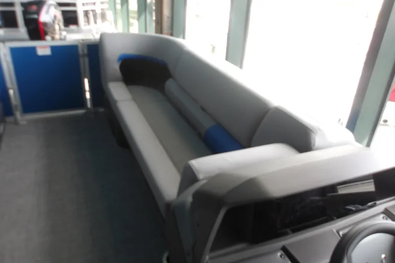 Slide: The Image of Interior of 2026 Sun Tracker Party Barge 20 DLX with gray seating and blue accents. - 14
