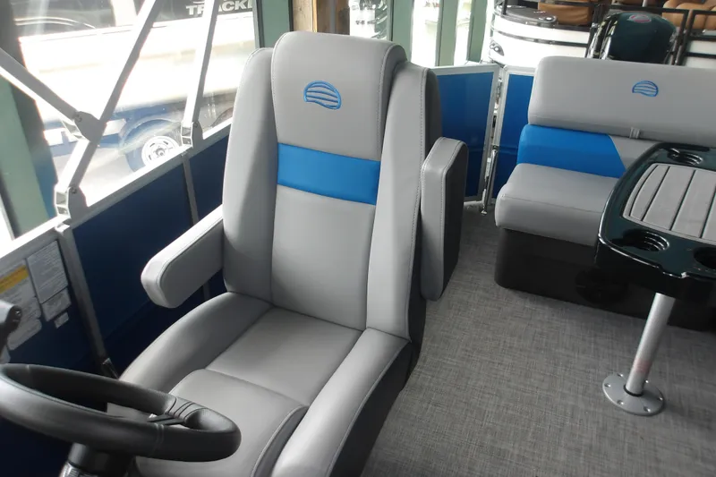Slide: The Image of 2026 Sun Tracker Party Barge 20 DLX interior with gray and blue seating. - 11