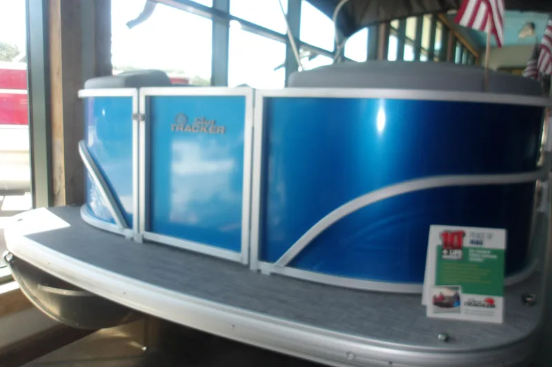 Slide: The Image of 2026 Sun Tracker Party Barge 20 DLX pontoon boat in showroom display. - 3