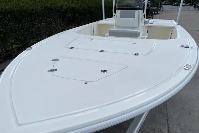 Slide: The Image of 2026 Mako 18 Pro Skiff boat with sleek white deck and storage compartments. - 7