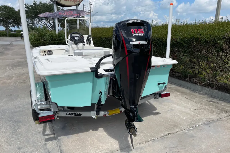 Slide: The Image of 2026 Mako 18 Pro Skiff with Mercury 115 outboard motor, parked on a trailer. - 3