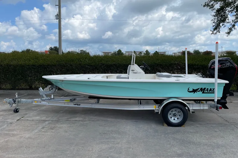 The Image of 2026 Mako 18 Pro Skiff boat on trailer, parked outdoors under cloudy sky. - 0