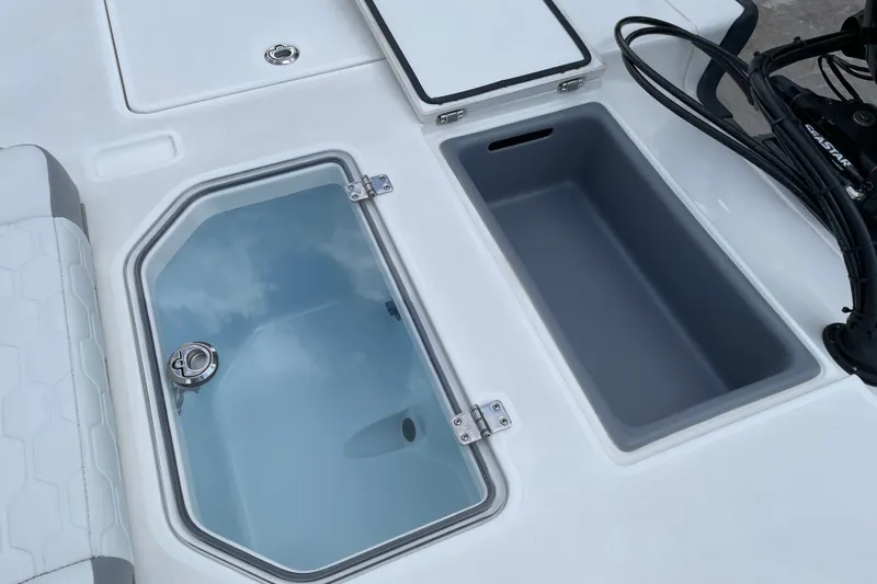 Slide: The Image of 2026 Mako 18 Pro Skiff boat deck with storage compartments and seating. - 15