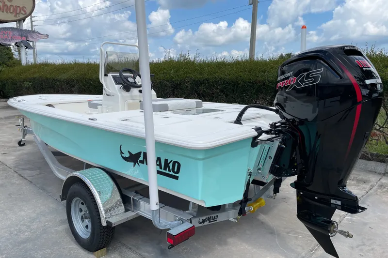 Slide: The Image of 2026 Mako 18 Pro Skiff boat with Mercury Pro XS engine on trailer. - 2