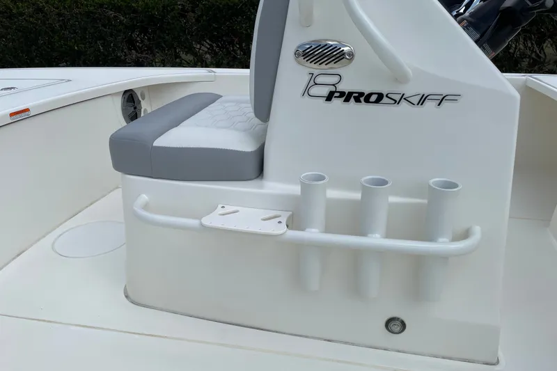 Slide: The Image of 2026 Mako 18 Pro Skiff boat interior with seating and rod holders. - 9