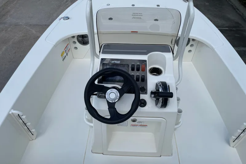 Slide: The Image of 2026 Mako 18 Pro Skiff boat console with steering wheel and controls. - 10