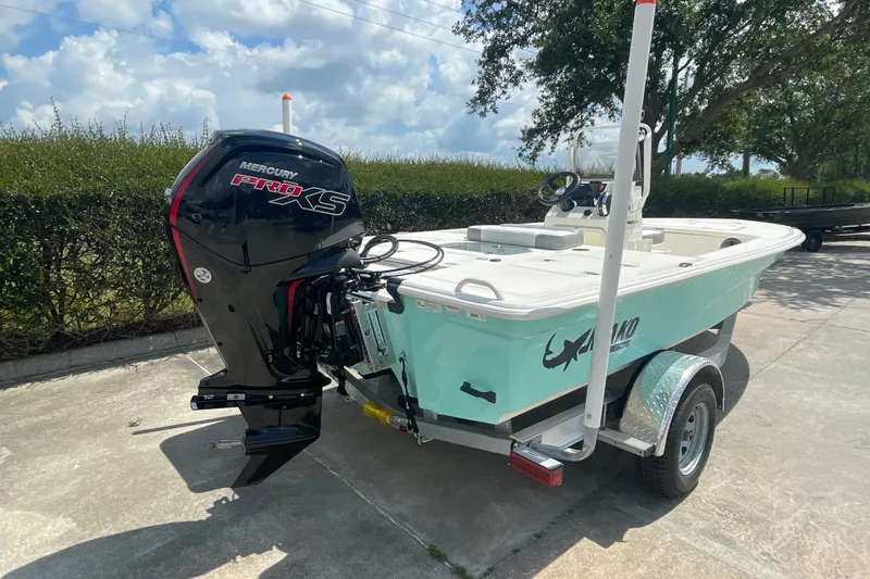 Slide: The Image of 2026 Mako 18 Pro Skiff boat with Mercury Pro XS engine on trailer. - 6