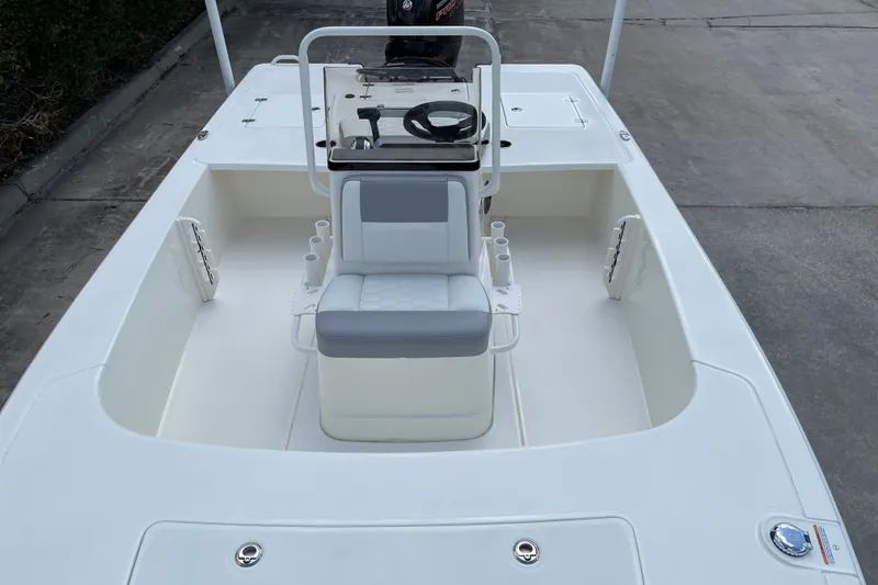 Slide: The Image of 2026 Mako 18 Pro Skiff boat interior with steering console and seating. - 12