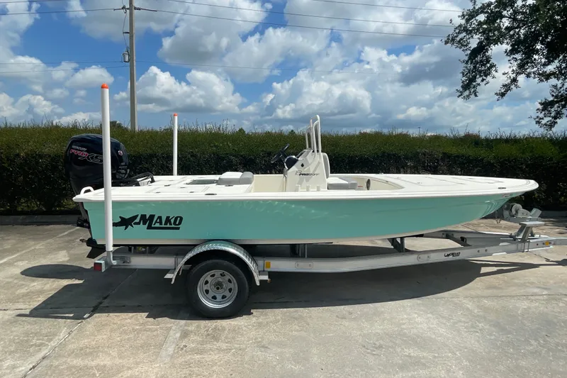 Slide: The Image of 2026 Mako 18 Pro Skiff boat on trailer under a blue sky. - 4
