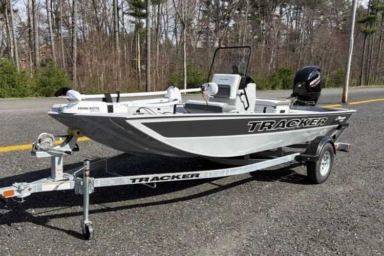 The Image of 2026 Tracker Bass Tracker Classic CC boat on trailer, parked on a road near trees. - 0