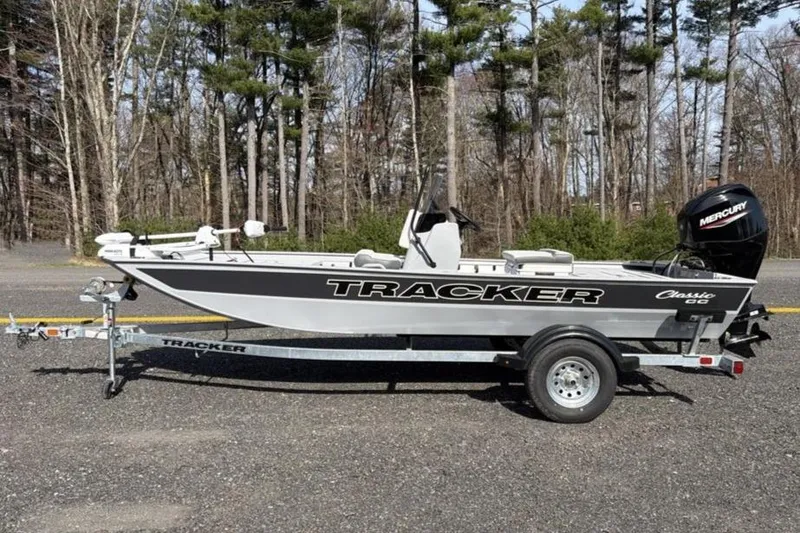Slide: The Image of 2026 Tracker Bass Tracker Classic CC boat on trailer, parked outdoors. - 2