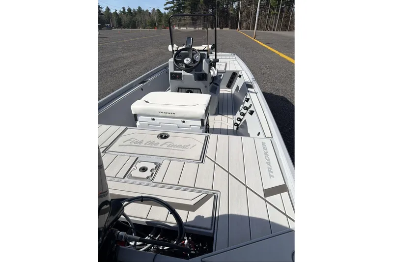 Slide: The Image of 2026 Tracker Bass Tracker Classic CC boat interior with steering console and seating. - 7