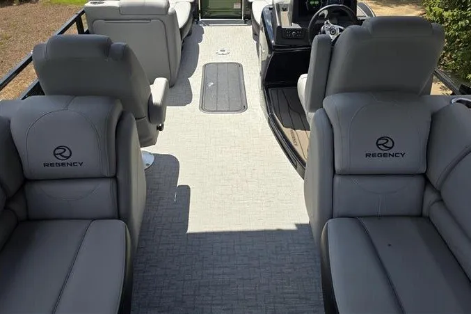 Slide: The Image of 2026 Regency 230 DL boat interior with gray seating and modern design. - 14