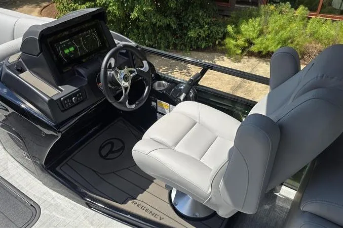 Slide: The Image of 2026 Regency 230 DL boat cockpit with modern steering and plush seating. - 13