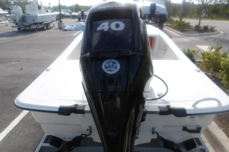 Slide: The Image of 2026 Mako Pro Skiff 13 CC with 40 HP outboard motor in parking lot. - 7