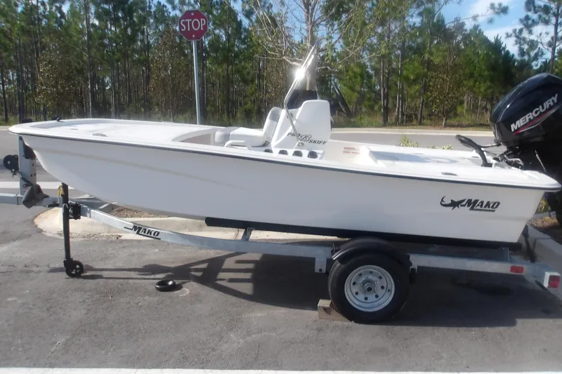 The Image of 2026 Mako Pro Skiff 13 CC boat on trailer, parked near a stop sign. - 1